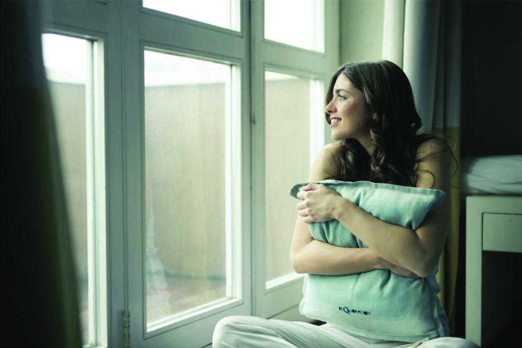 a relaxed girl sitting and looking out of the window